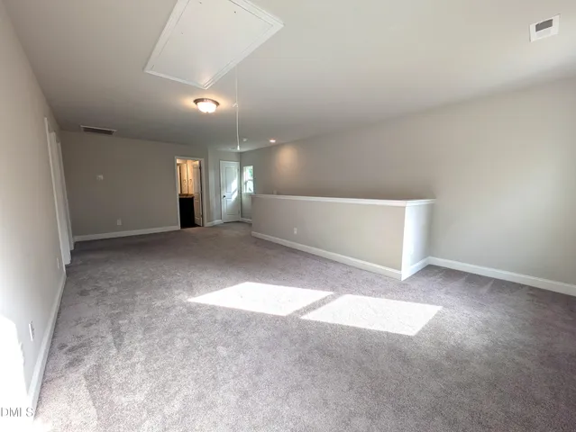 a view of a big room with a ceiling fan and window