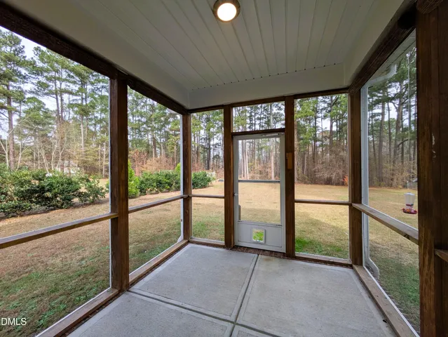 a view of an empty room with windows and city view