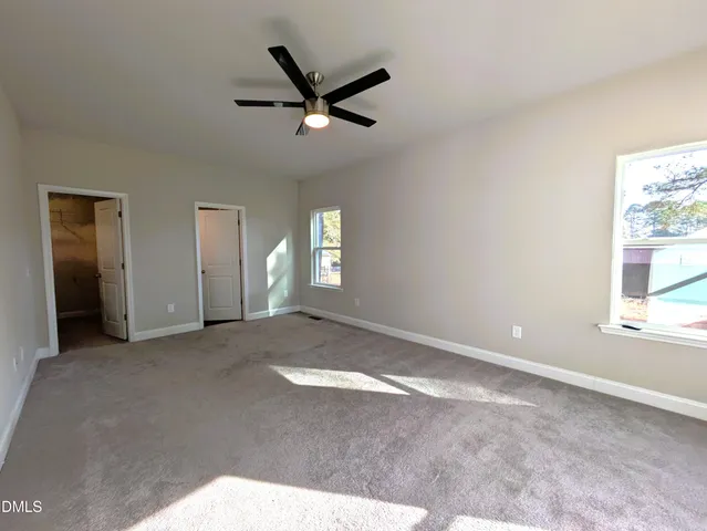a view of a livingroom with a ceiling fan and window