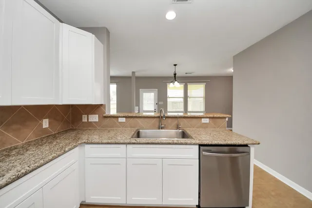 a kitchen with granite countertop white cabinets and a granite counter tops