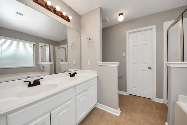 a bathroom with a double vanity sink a mirror and a