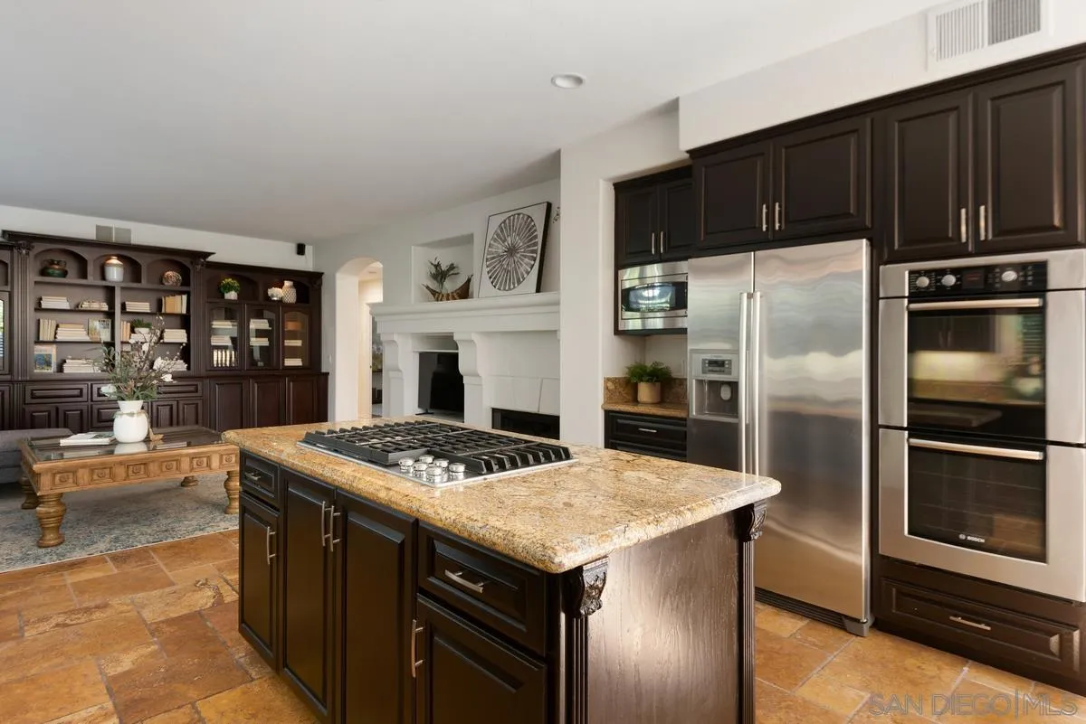 4889 Riding Ridge Road San Diego, CA 92130 - Photo 17 of 34 a kitchen with stainless steel appliances granite countertop a stove a refrigerator and a stove