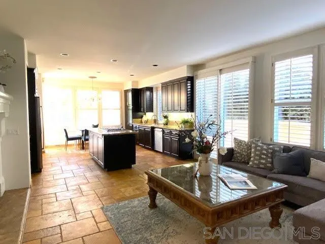 4889 Riding Ridge Road San Diego, CA 92130 - Photo 21 of 34 a living room with patio furniture and a table