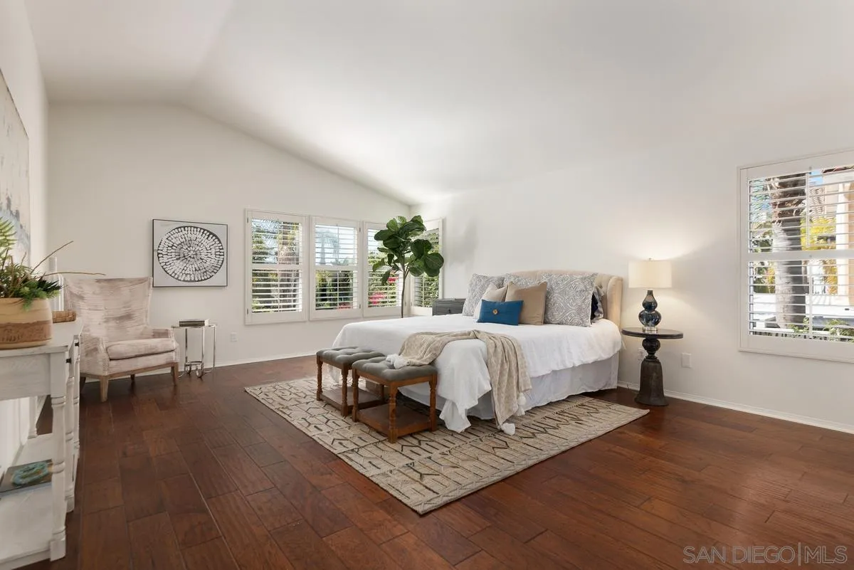 4889 Riding Ridge Road San Diego, CA 92130 - Photo 24 of 34 a bed room with a bed and a table