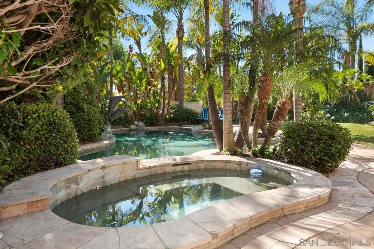 4889 Riding Ridge Road San Diego, CA 92130 - Photo 3 of 34 a view of a swimming pool with a sitting area