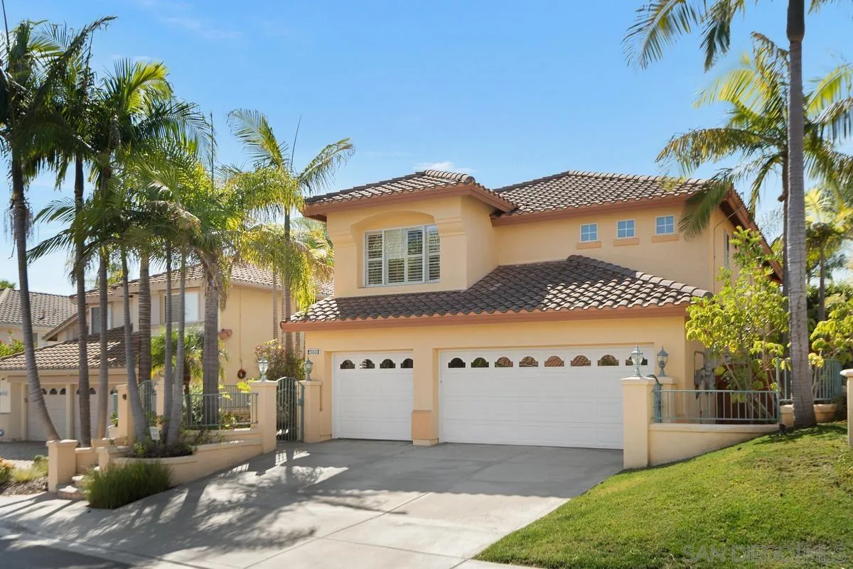 4889 Riding Ridge Road San Diego, CA 92130 - Photo 34 of 34 a front view of a house with a yard and garage