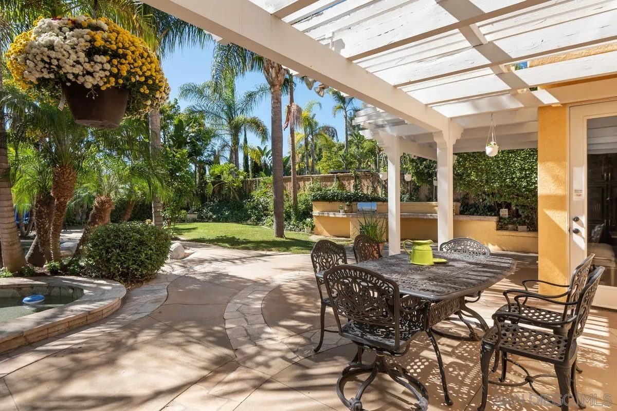 4889 Riding Ridge Road San Diego, CA 92130 - Photo 6 of 34 a view of a patio with a table chairs and a backyard
