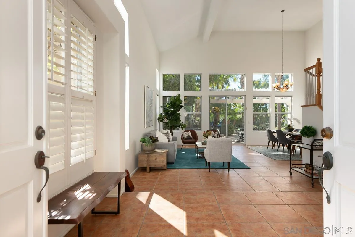 4889 Riding Ridge Road San Diego, CA 92130 - Photo 8 of 34 a living room with furniture and large windows
