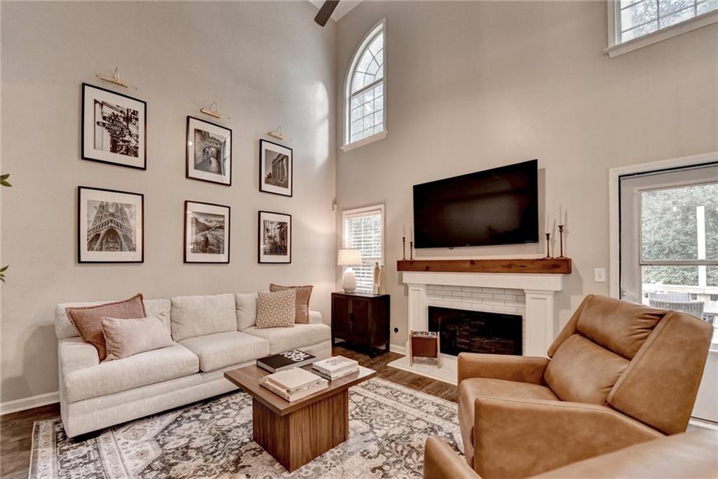 1130 Rome Drive Roswell, GA 30075 - Photo 23 of 96 a living room with furniture a flat screen tv and a fireplace