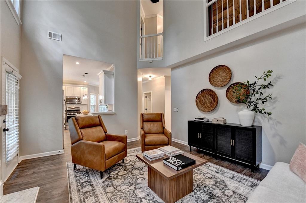 1130 Rome Drive Roswell, GA 30075 - Photo 27 of 96 a living room with furniture a rug and a fireplace
