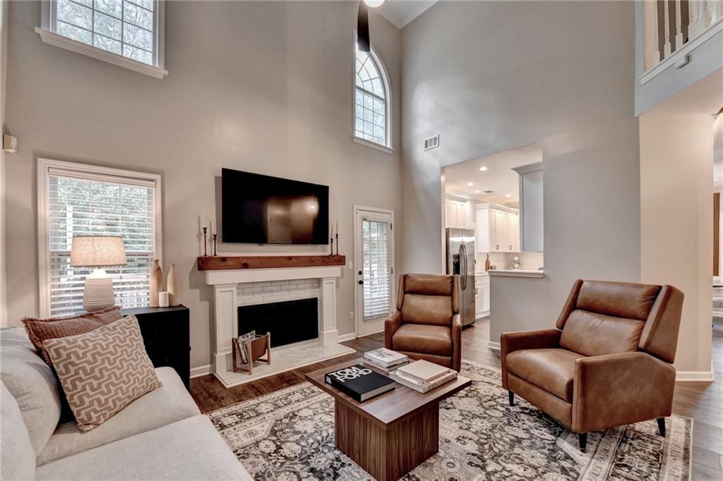 1130 Rome Drive Roswell, GA 30075 - Photo 28 of 96 a living room with furniture a flat screen tv and a fireplace
