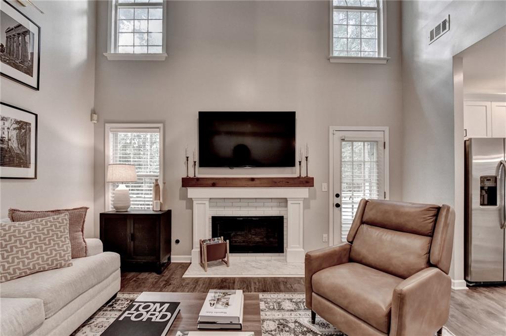 1130 Rome Drive Roswell, GA 30075 - Photo 29 of 96 a living room with furniture a flat screen tv and a fireplace