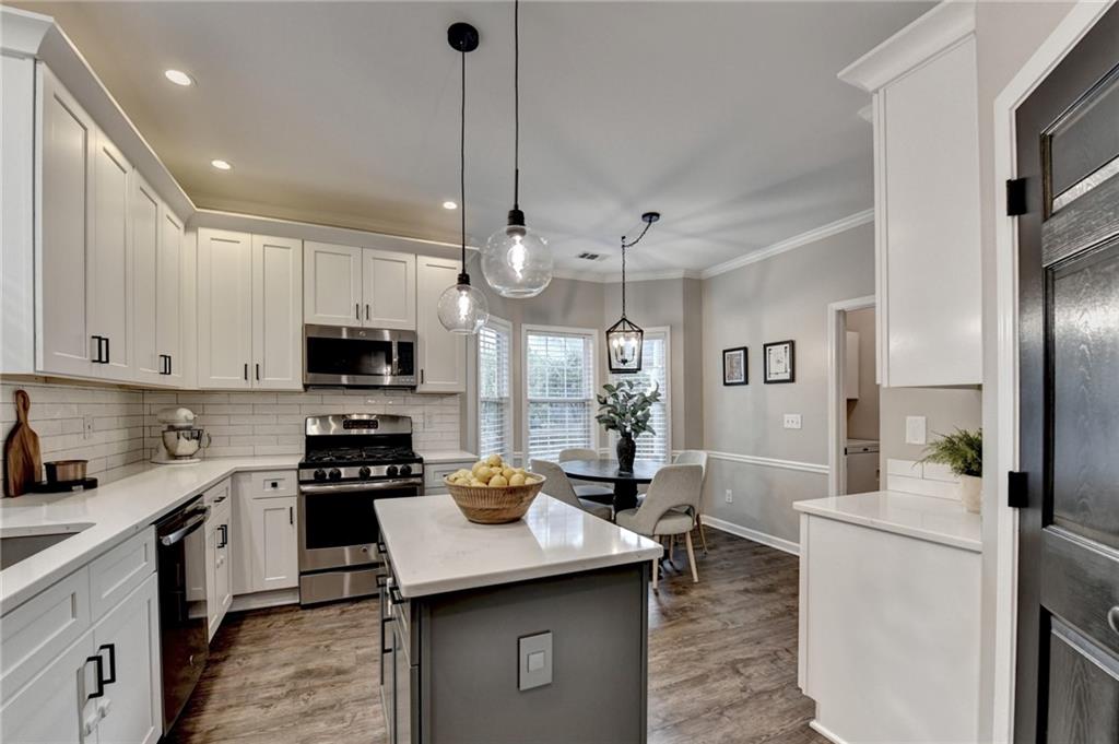 1130 Rome Drive Roswell, GA 30075 - Photo 32 of 96 a kitchen with stainless steel appliances kitchen island granite countertop a sink a stove and a refrigerator