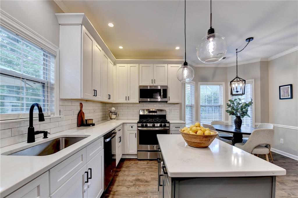 1130 Rome Drive Roswell, GA 30075 - Photo 34 of 96 a kitchen with a sink a counter space cabinets and appliances