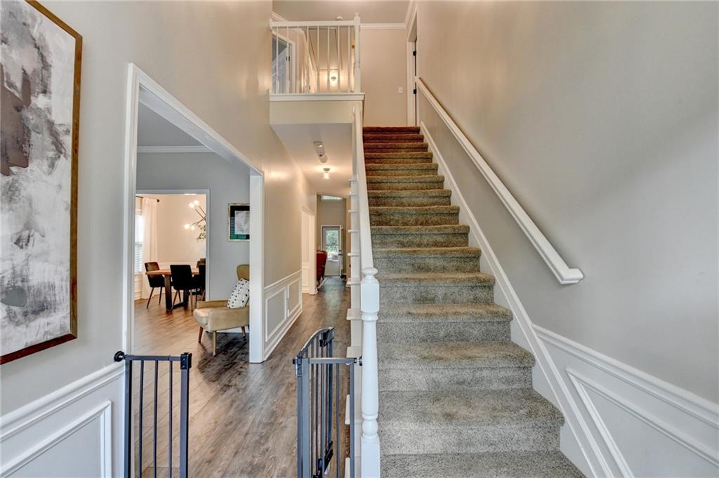 1130 Rome Drive Roswell, GA 30075 - Photo 4 of 96 a view of a hallway with wooden floor and staircase