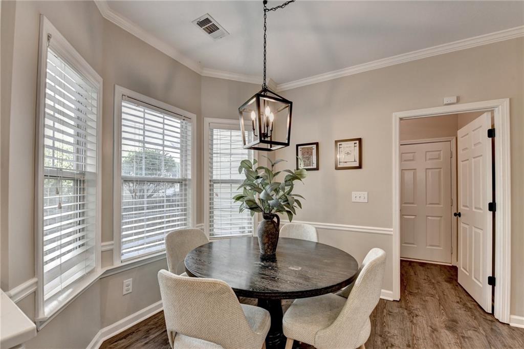 1130 Rome Drive Roswell, GA 30075 - Photo 42 of 96 a dining room with furniture and wooden floor