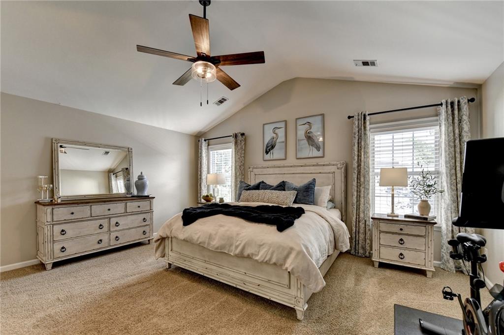 1130 Rome Drive Roswell, GA 30075 - Photo 50 of 96 a spacious bedroom with a bed and a flat screen tv