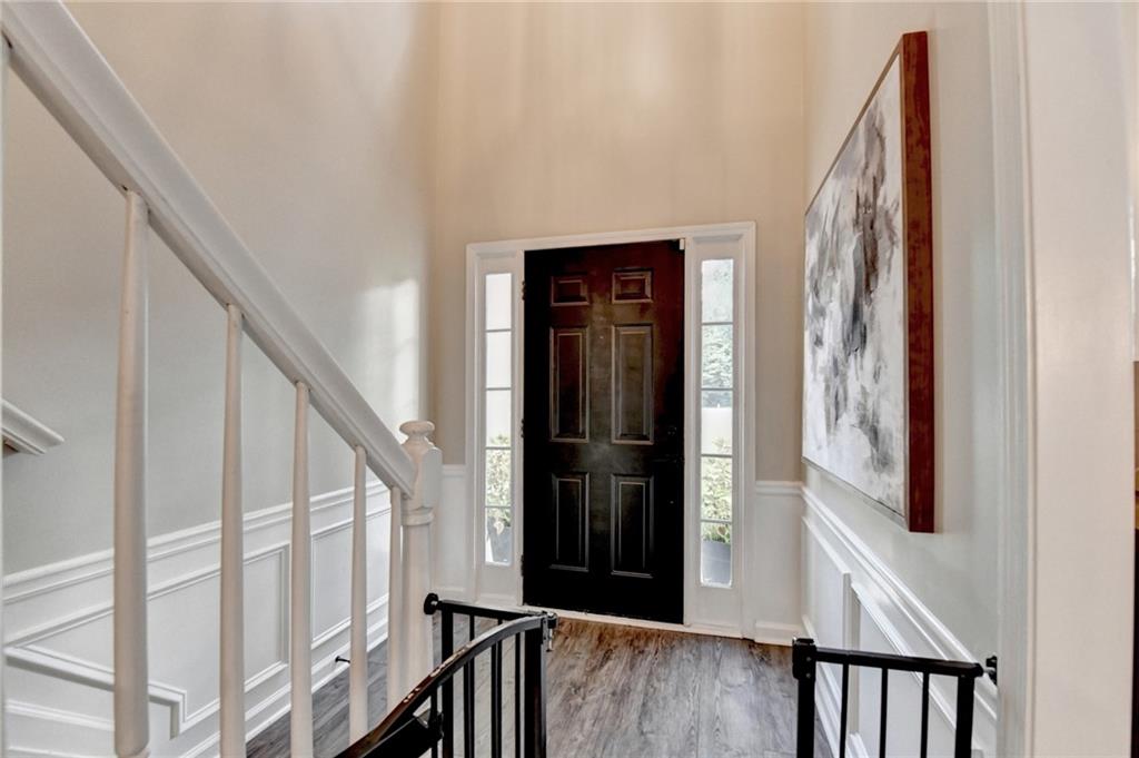 1130 Rome Drive Roswell, GA 30075 - Photo 5 of 96 a view of a hallway with wooden floor and staircase