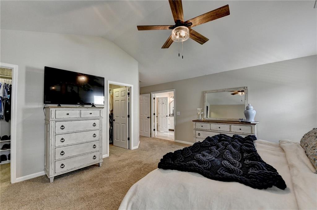 1130 Rome Drive Roswell, GA 30075 - Photo 51 of 96 a bedroom with a bed and a flat tv screen on dresser