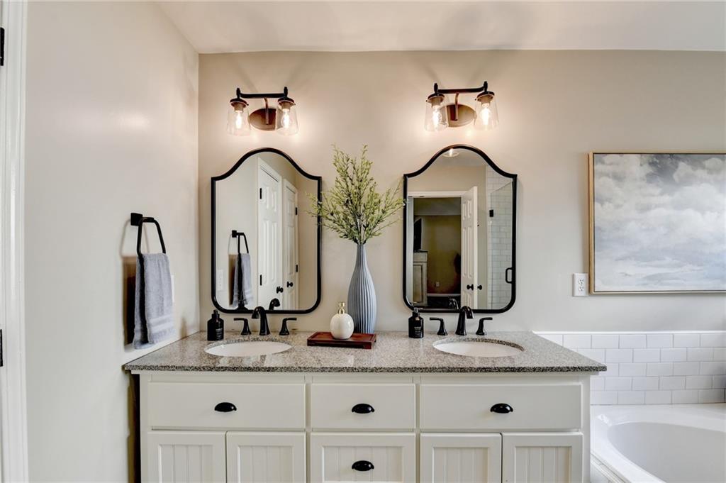 1130 Rome Drive Roswell, GA 30075 - Photo 55 of 96 a bathroom with a double vanity sink and mirror