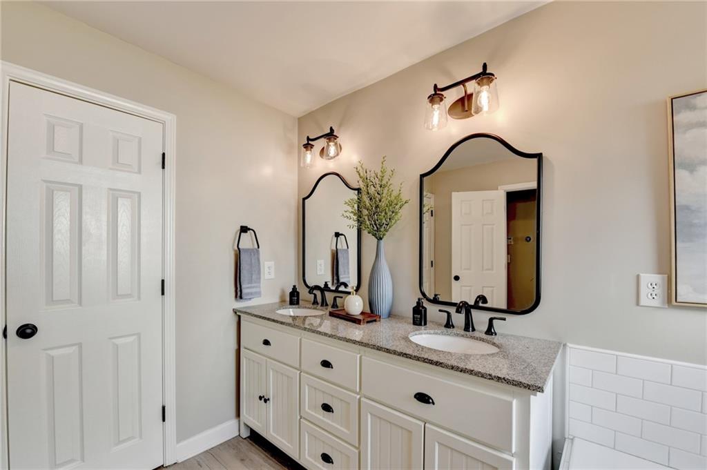 1130 Rome Drive Roswell, GA 30075 - Photo 58 of 96 a bathroom with double vanity sinks and a mirror