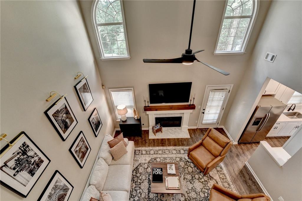 1130 Rome Drive Roswell, GA 30075 - Photo 73 of 96 a living room with furniture a flat screen tv and a fireplace