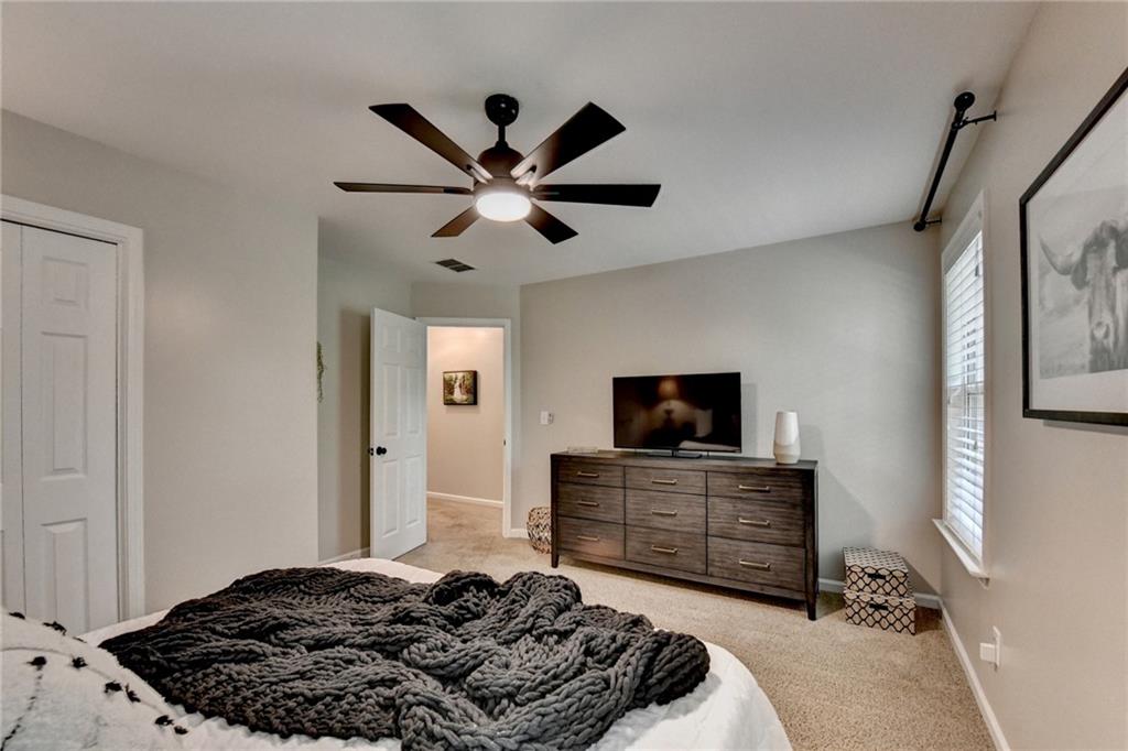 1130 Rome Drive Roswell, GA 30075 - Photo 78 of 96 a bedroom with a bed and a flat tv screen on dresser