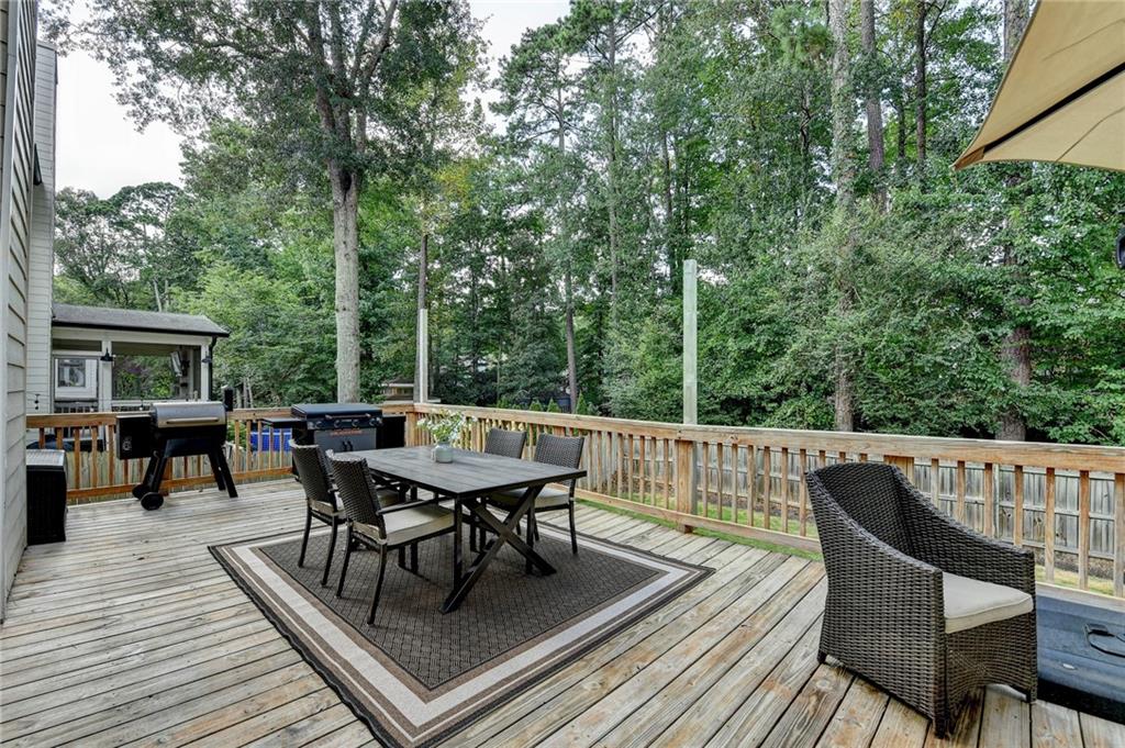 1130 Rome Drive Roswell, GA 30075 - Photo 81 of 96 a roof deck with a dining table and chairs with wooden floor