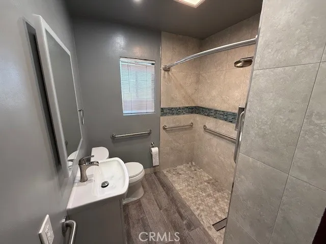 a bathroom with a sink toilet and shower