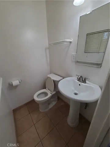a bathroom with a sink toilet and a mirror