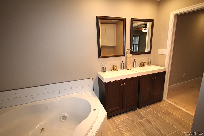 2809 Banbury Road Chester, VA 23831 - Photo 16 of 47 a spacious bathroom with a tub sink and mirror