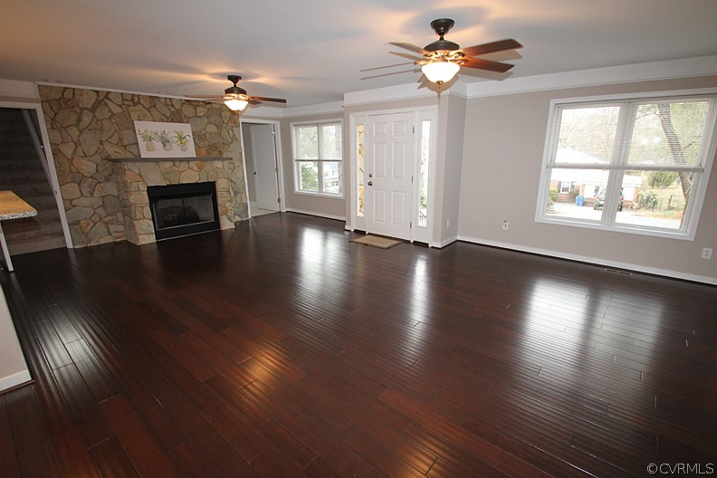 2809 Banbury Road Chester, VA 23831 - Photo 4 of 47 a view of a livingroom with wooden floor a ceiling fan and a window