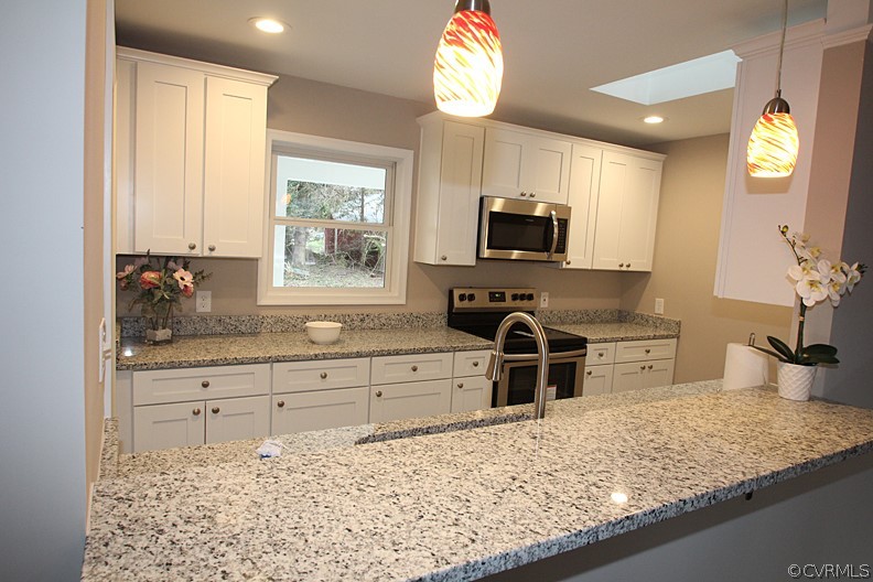 2809 Banbury Road Chester, VA 23831 - Photo 8 of 47 a kitchen with stainless steel appliances granite countertop a sink stove and microwave