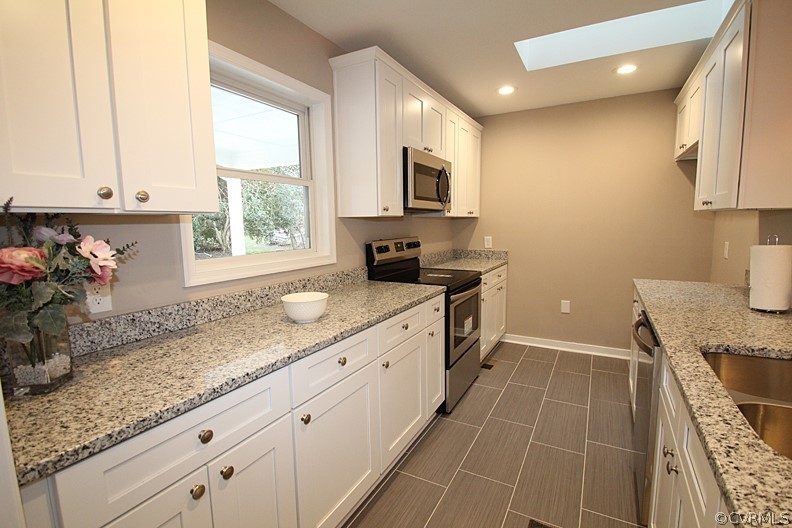 2809 Banbury Road Chester, VA 23831 - Photo 9 of 47 a kitchen with granite countertop a sink a stove and cabinets