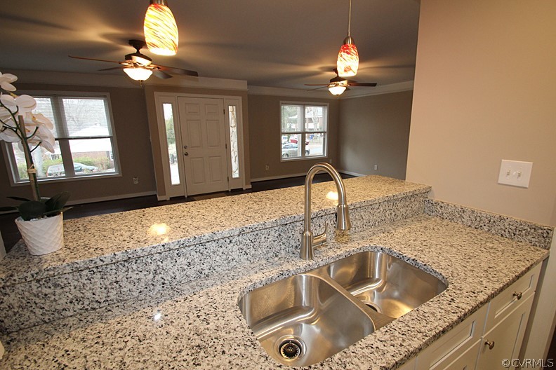 2809 Banbury Road Chester, VA 23831 - Photo 10 of 47 a kitchen sink with granite countertop a sink and a chandelier