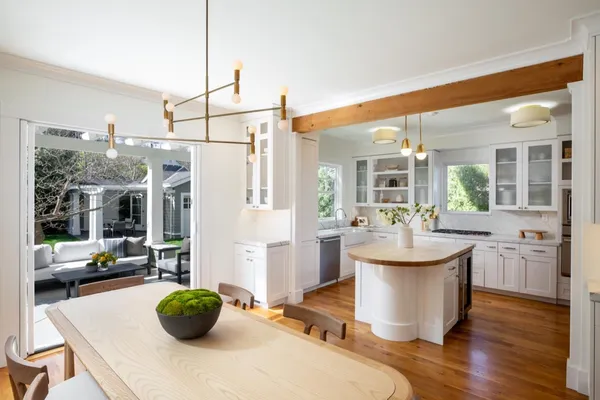 a living room with furniture a flat screen tv and kitchen view