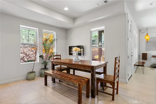 a kitchen with stainless steel appliances a stove top oven a sink dishwasher and a refrigerator with wooden cabinets