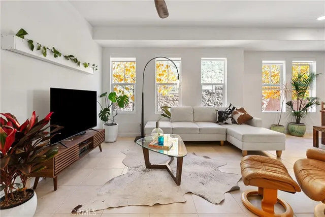 a living room with furniture and a potted plant