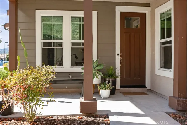 an aerial view of residential houses with outdoor space and parking