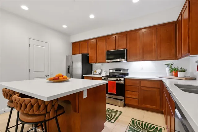 a kitchen with stainless steel appliances granite countertop a sink stove and cabinets