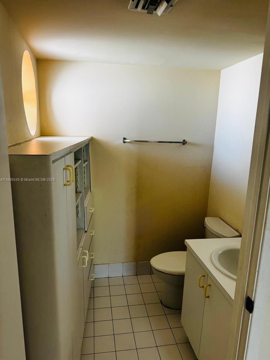 9156 Collins Avenue, Unit 310 Surfside, FL 33154 - Photo 11 of 22 a bathroom with a sink and a toilet