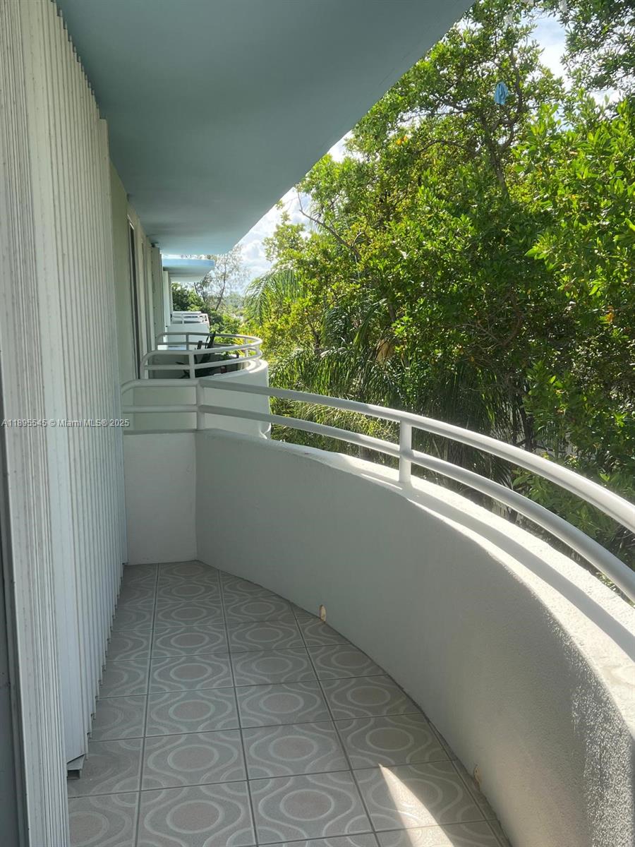 9156 Collins Avenue, Unit 310 Surfside, FL 33154 - Photo 16 of 22 a view of a balcony and trees