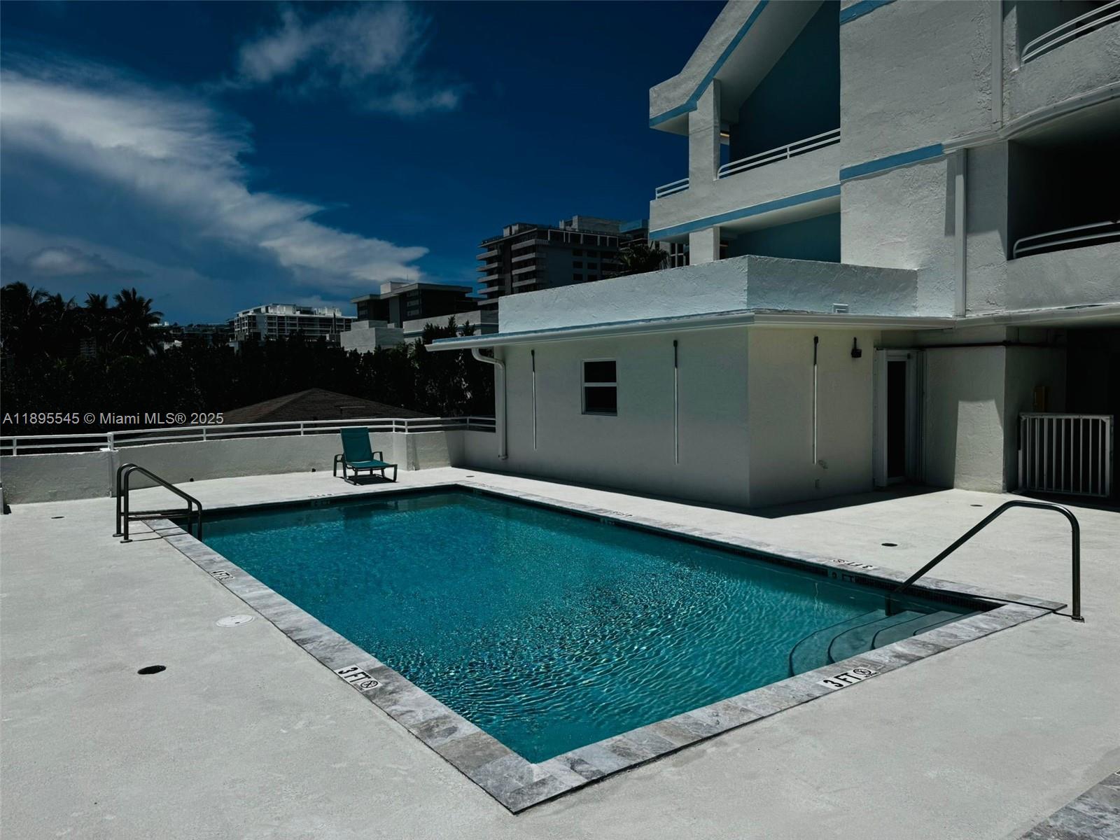9156 Collins Avenue, Unit 310 Surfside, FL 33154 - Photo 19 of 22 a view of a terrace with a table and chairs