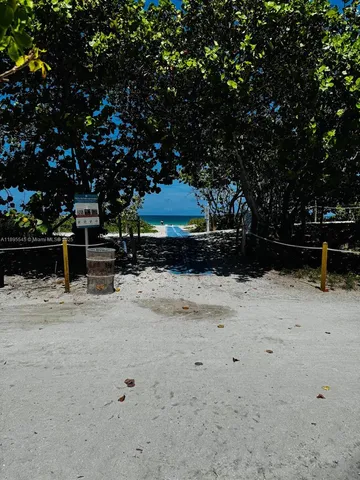 a view of golf course with parking space