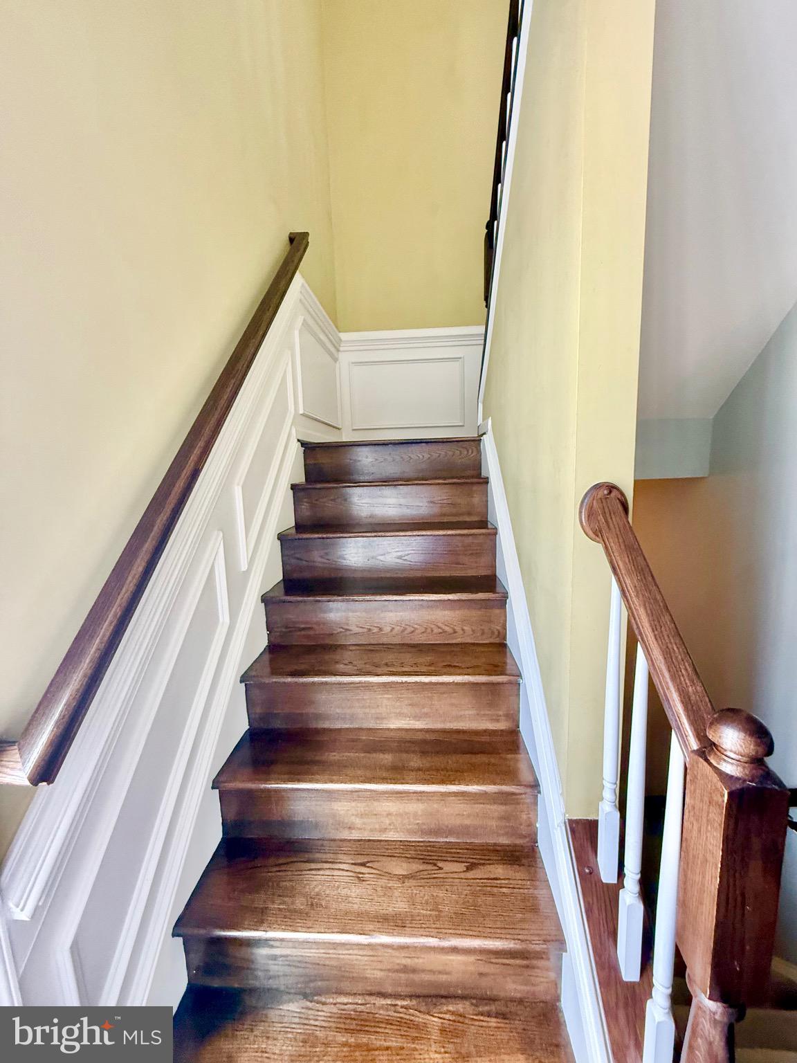 23479 Buckland Farm Terrace Ashburn, VA 20148 - Photo 11 of 17 a view of staircase with wooden floor and white walls