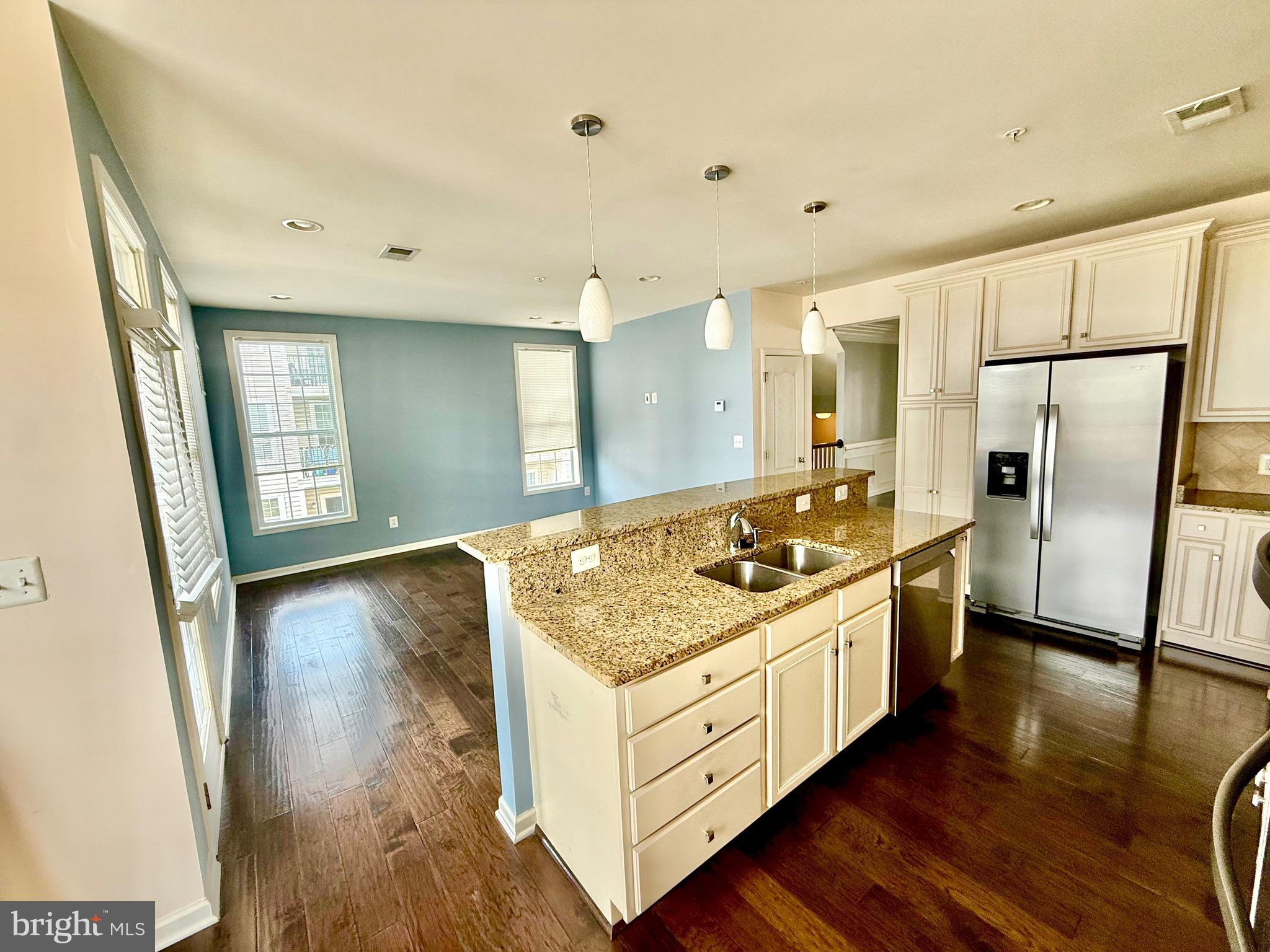 23479 Buckland Farm Terrace Ashburn, VA 20148 - Photo 15 of 17 a kitchen with stainless steel appliances granite countertop a sink stove and refrigerator