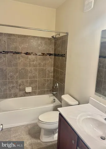 a bathroom with a toilet a sink and bathtub