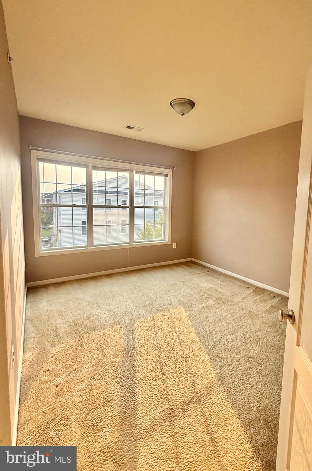 23479 Buckland Farm Terrace Ashburn, VA 20148 - Photo 6 of 17 a view of an empty room with a window