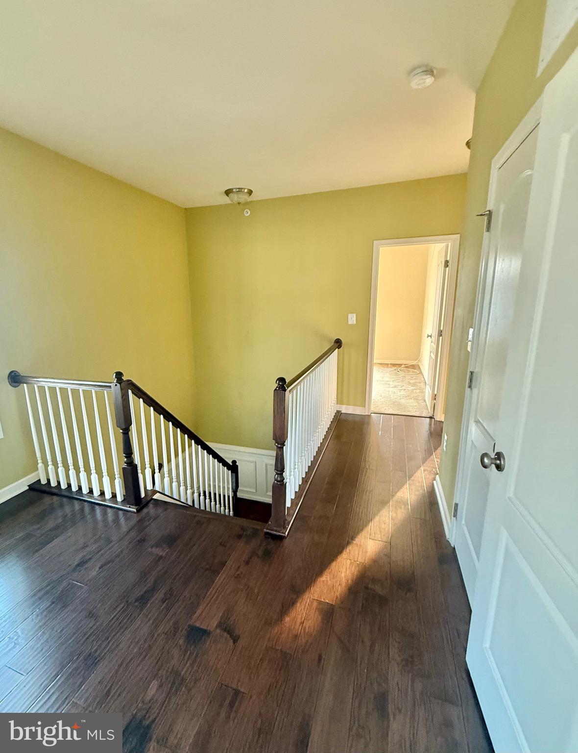 23479 Buckland Farm Terrace Ashburn, VA 20148 - Photo 8 of 17 a view of a hallway with wooden floor and staircase