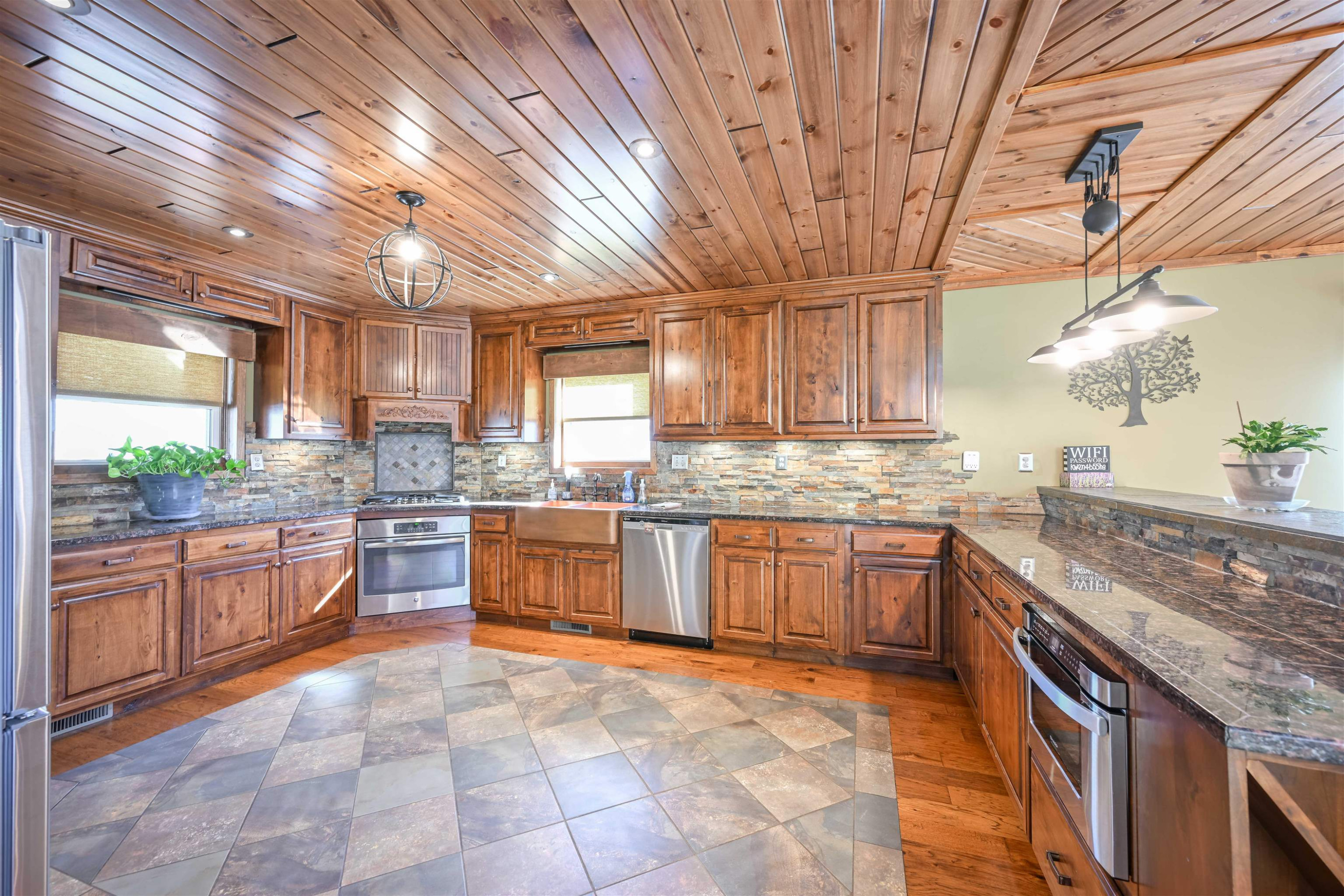 576 Ridgeway Road Sugar Tree, TN 38380 - Photo 24 of 66 a large kitchen with kitchen island granite countertop wooden cabinets a granite counter tops and a stove